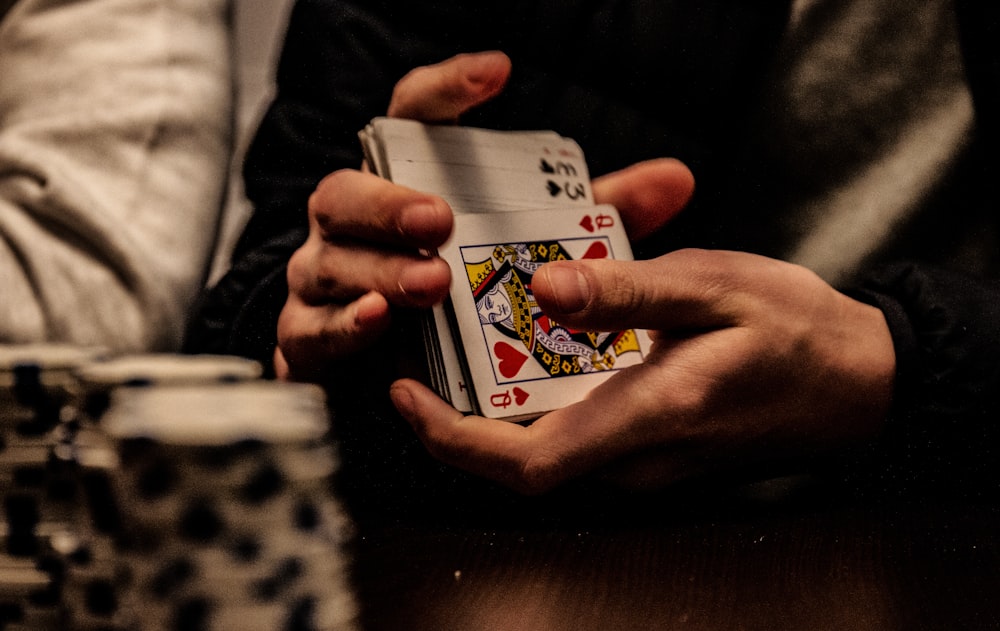 Tangan memegang kartu As Keriting — kartu tertinggi di poker